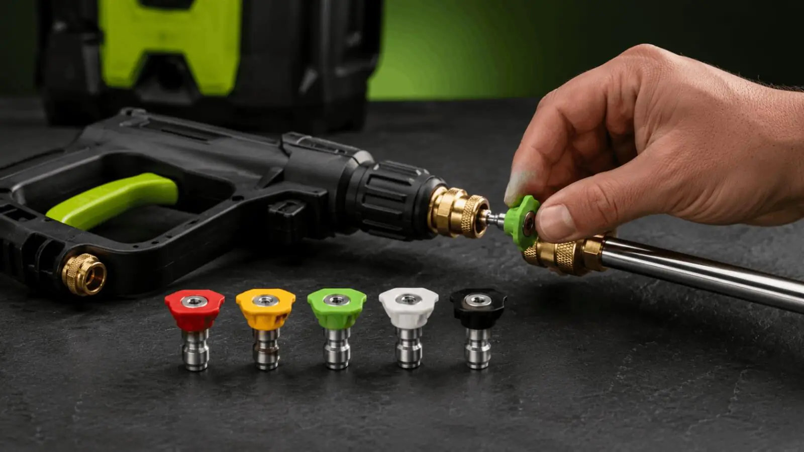 Hand attaching a green quick connect nozzle to the spray wand of a Sun Joe SPX3000 pressure washer.