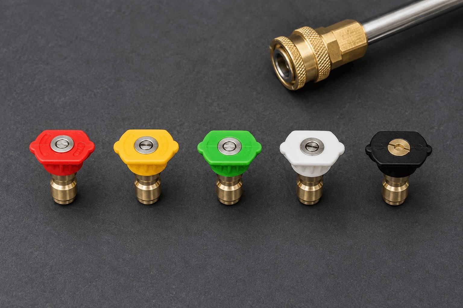 Five color-coded quick-connect spray nozzle tips (0, 15, 25, 40 degrees, and soap tip) lined up next to a pressure washer wand.