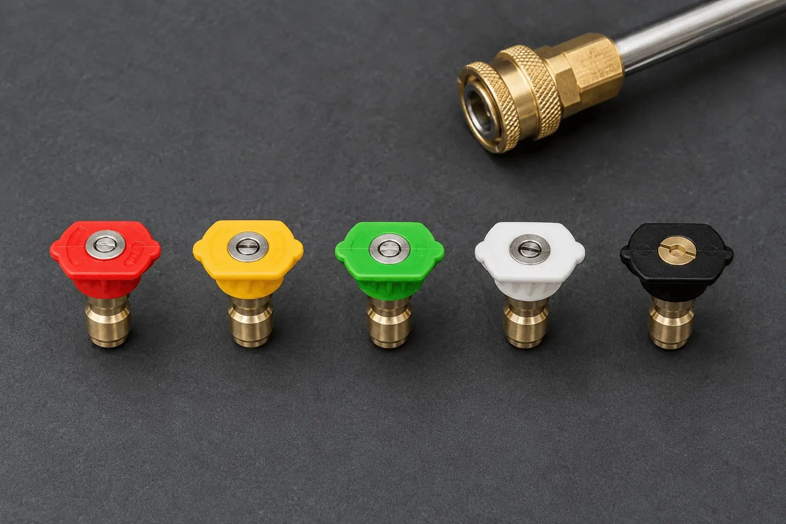 Five color-coded quick-connect spray nozzle tips (0, 15, 25, 40 degrees, and soap tip) lined up next to a pressure washer wand.