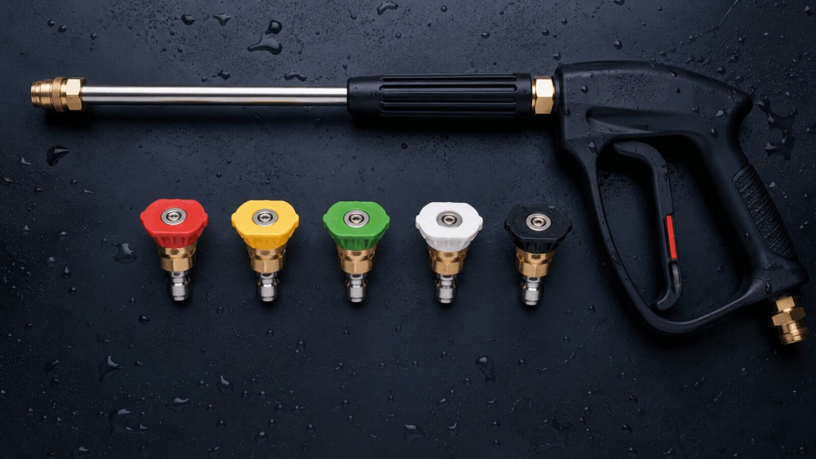 Set of five color-coded pressure washer quick connect nozzle tips with high pressure spray wand